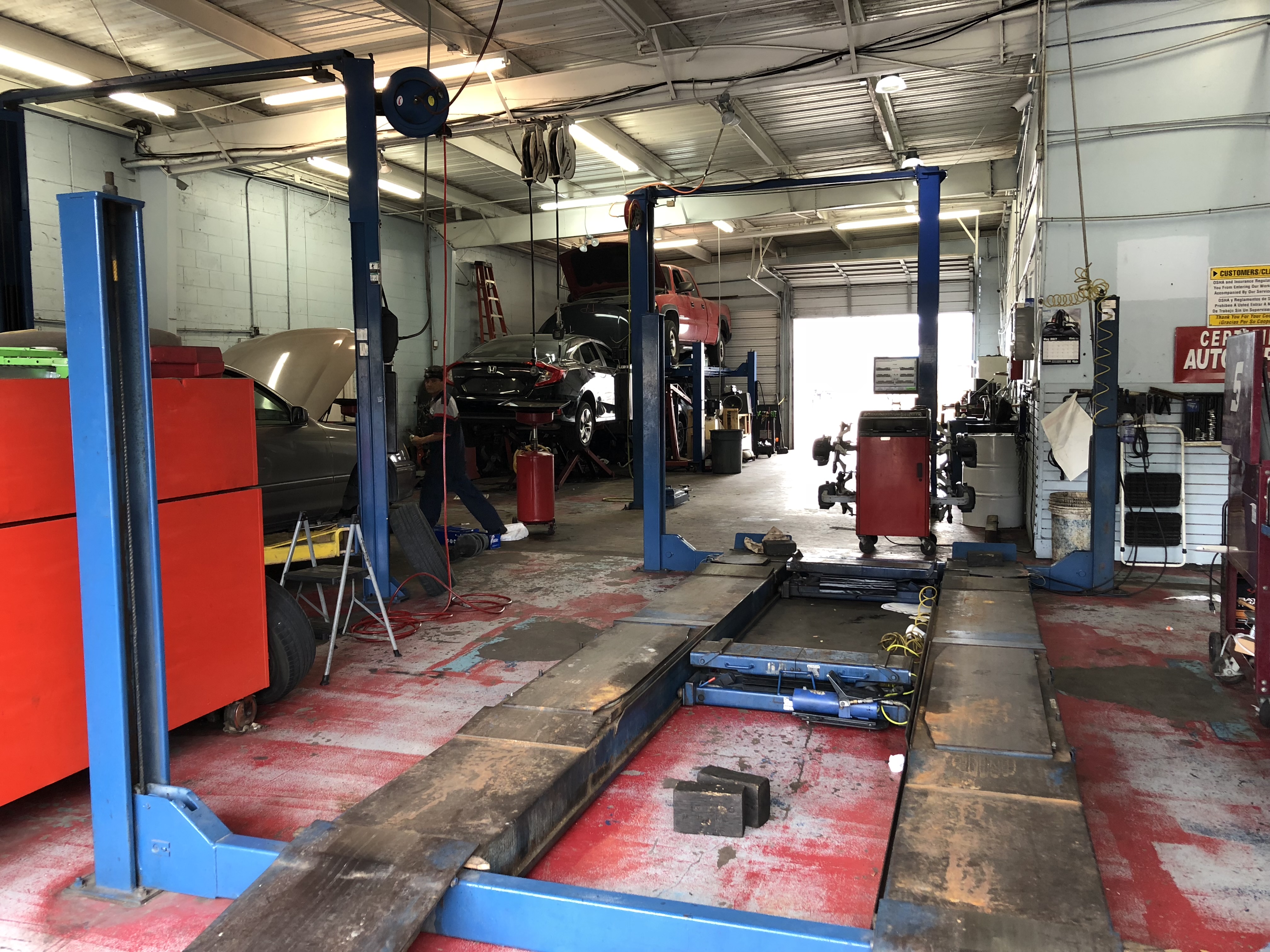 Lonestar Auto Repair shop interior with multiple service bays and hydraulic lifts